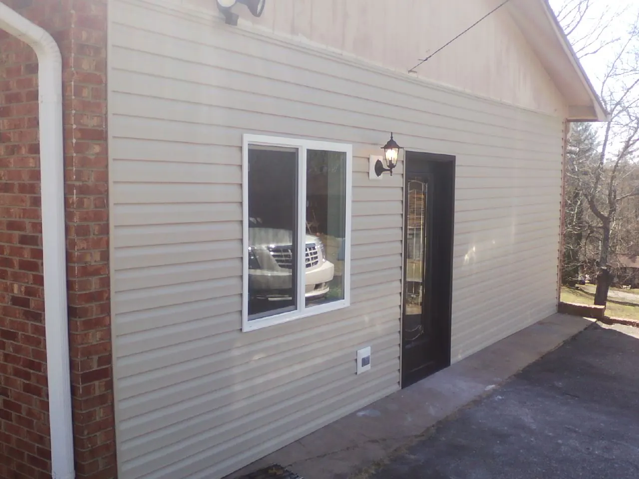 New vinyl siding and entry door on a room addition in Bonner Springs