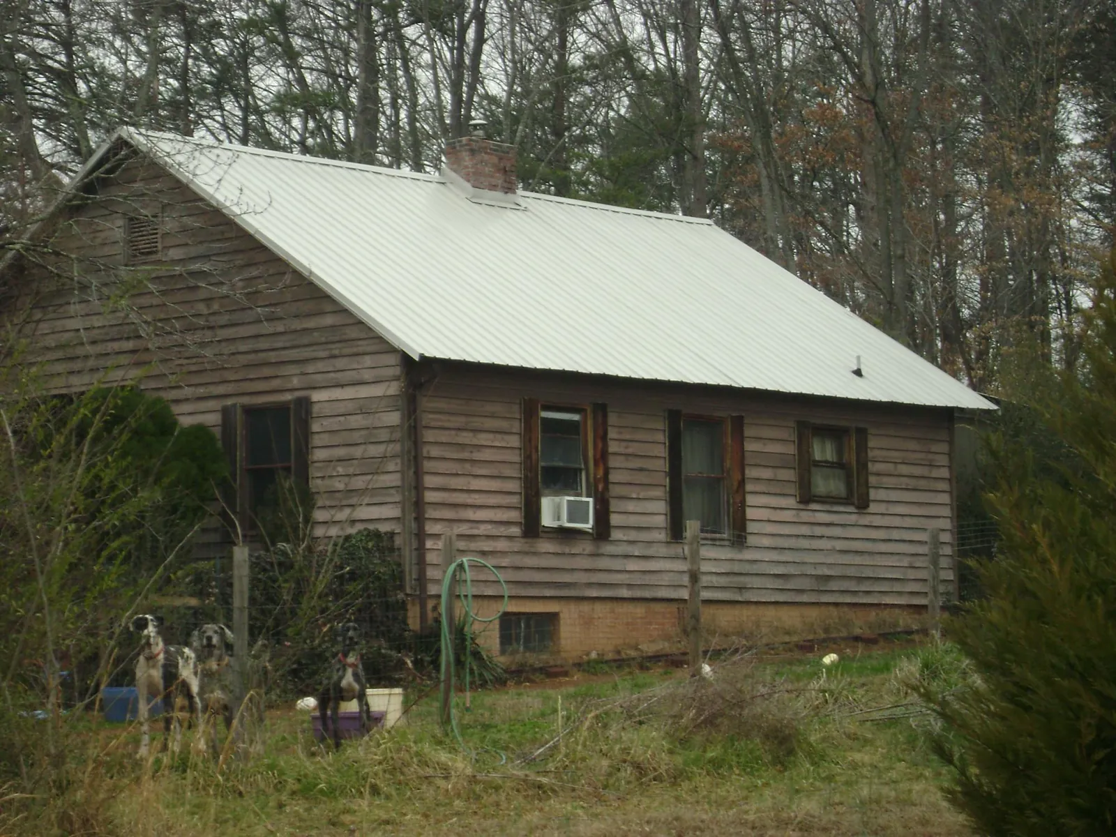 White metal roof on an old wood sided farmhouse, from a Asphalt Shingle Roof Repair job in Bonner Springs
